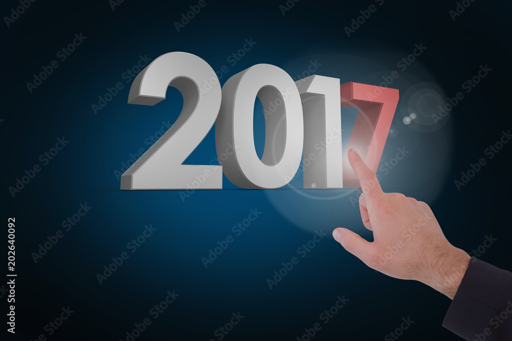 Businessmans hand pointing in suit jacket against blue background with vignette Businessmans hand pointing in suit jacket against blue background with vignette