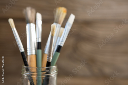 Various paintbrush in a glass jar