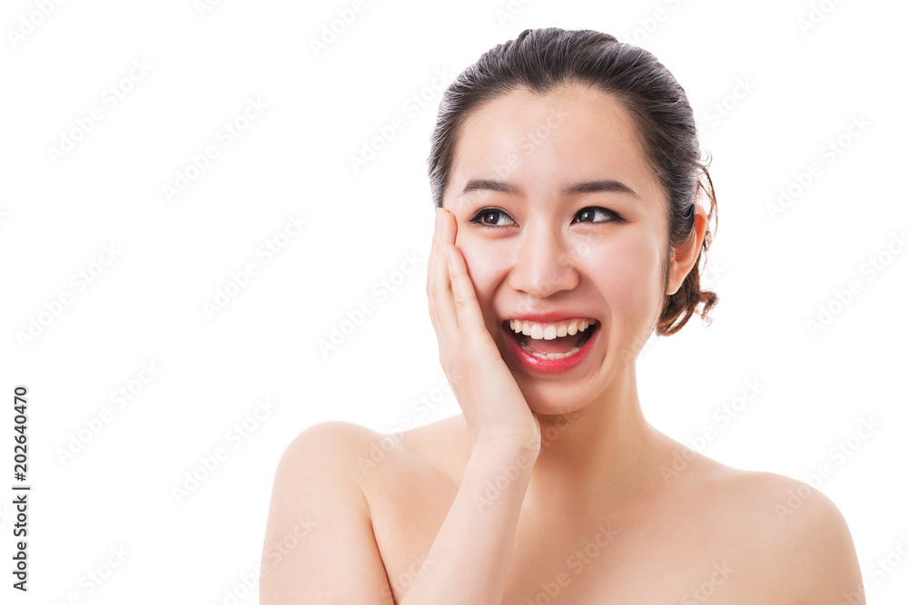 Beautiful face of young smiling woman with clean fresh skin. Touching face.