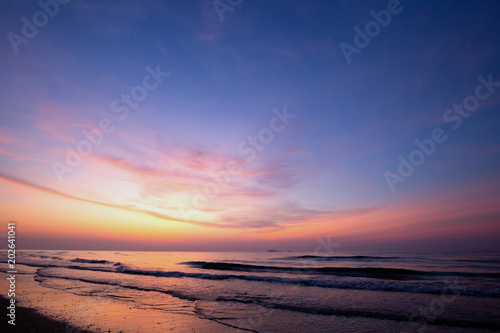 Nice sky  clouds and sun above the beautiful sea and sand beach with little waves at the morning moment.