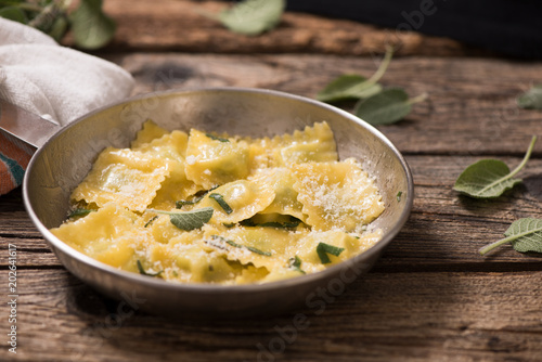 Italian cuisine: ravioli pasta with parmesan cheese and sage