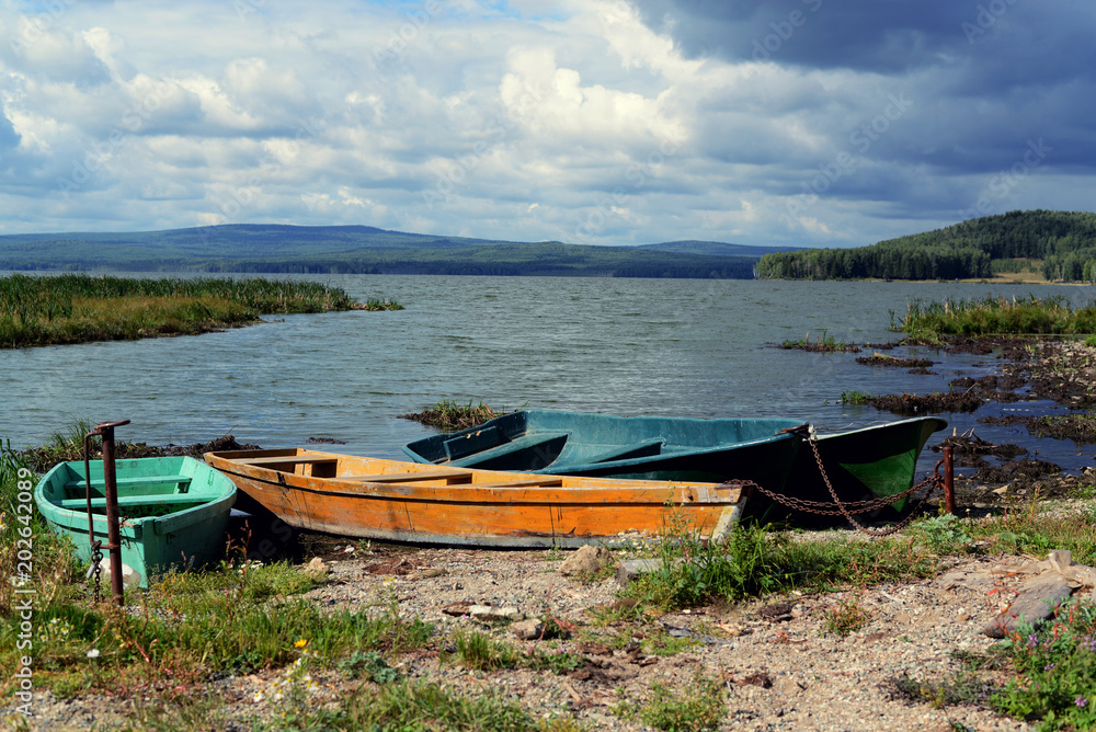 Old boats on the shore of the lake.