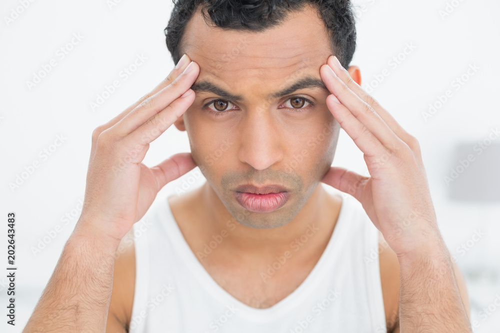 Closeup portrait of a man suffering from headache Closeup portrait of a man suffering from headache