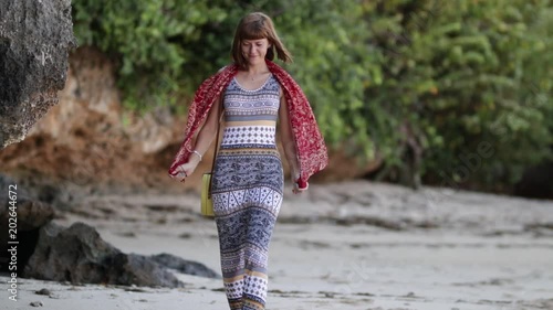 Woman with fashionable stylish yellow rattan bag on the beach. Tropical island of Bali. Handmade Rattan eco handbag HD footage. photo