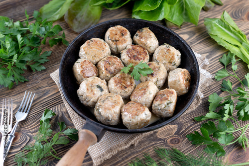 Homemade freshly cooked cutlets in a cast-iron frying pan. Top view. Food background.