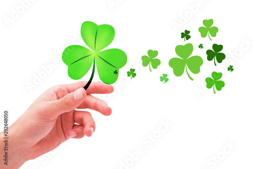 Shamrock against hand with raised fingers