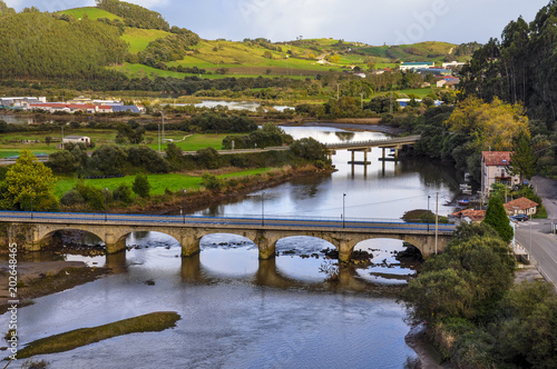 Small stone bridge across the river near the Pesues railway station in San Vicente de la Barquera, Spain photo