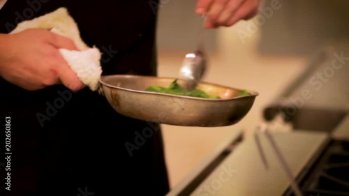 Wallpaper Mural Chef sautes  spinach at a high end restaurant in the Pacific Northwest Torontodigital.ca