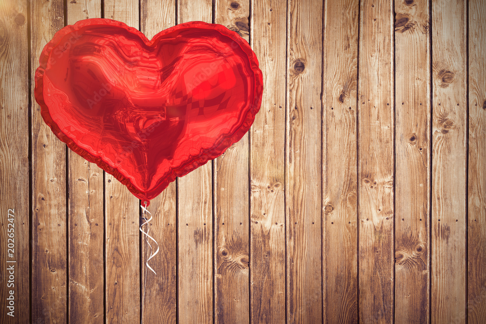 Red heart balloon against wooden planks 3d