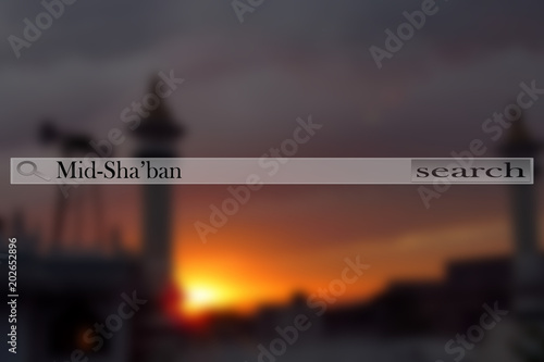 A mosque during the namaz time blurred and a search bar written Mid Sha’ban. The holy night between the month of Sha’ban between night 14-15. photo