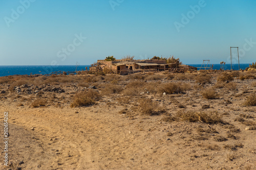old ranch on the Atlantic coast of the island of Tenerife. three horses and offroad car outside of a modern ranch in tenerife.