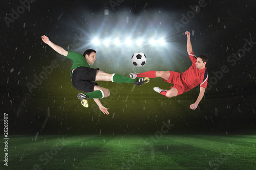 Football players tackling for the ball against football pitch under spotlights © vectorfusionart
