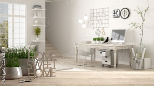Wooden table  desk or shelf with potted grass plant  house keys and 3D letters making the words home sweet home  over home workplace  architecture interior design  copy space background