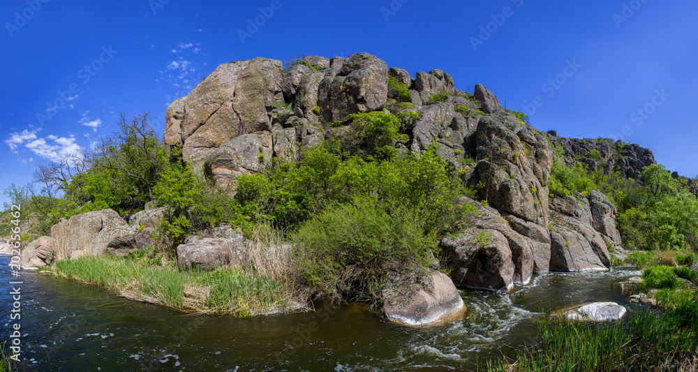 River in Aktovsky canyon, Ukraine. Big rocks in river, calm water.