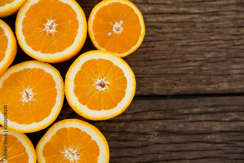 Halved oranges on wooden table Halved oranges on wooden table