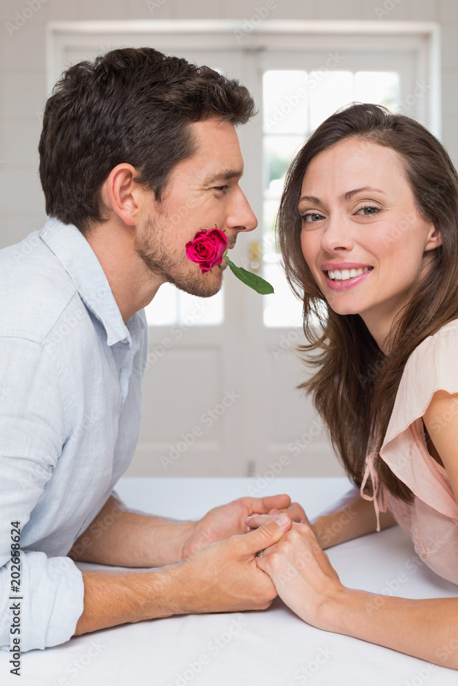Loving young couple holding hands at home Loving young couple holding hands at home