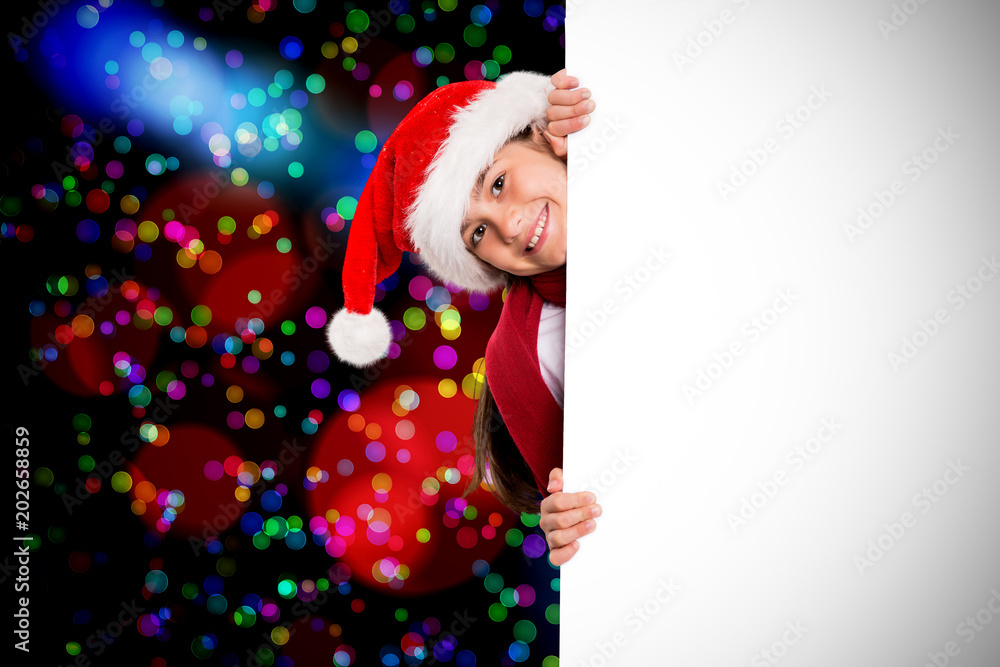 Festive little girl showing card against colourful glowing dots on black Festive little girl showing card against colourful glowing dots on black