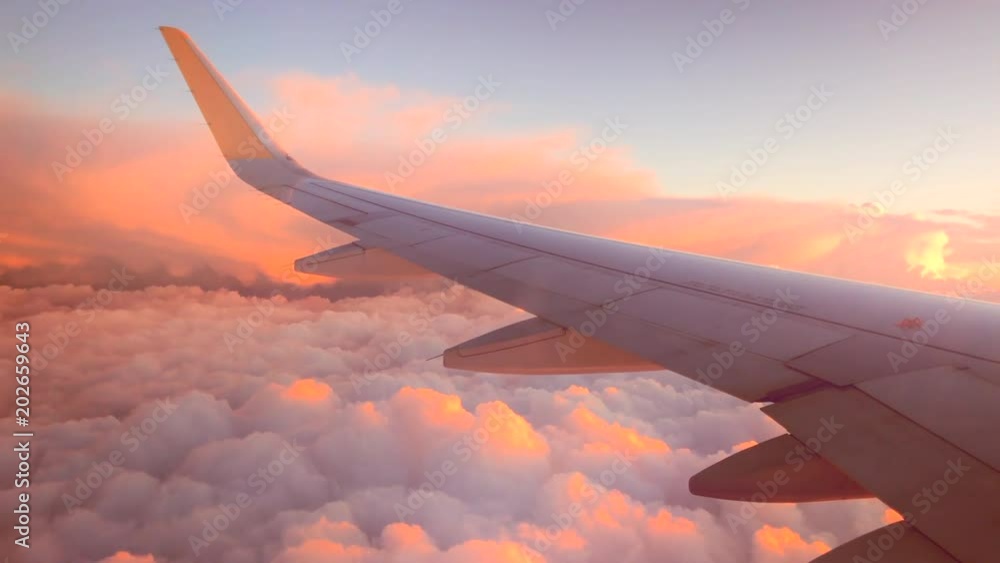 Airplane flight. Wing of an airplane flying above the clouds. View from the window of the plane. Aircraft. Traveling. 4K UHD video footage. 3840X2160 Airplane flight. Wing of an airplane flying above the clouds. View from the window of the plane. Aircraft. Traveling. 4K UHD video footage. 3840X2160