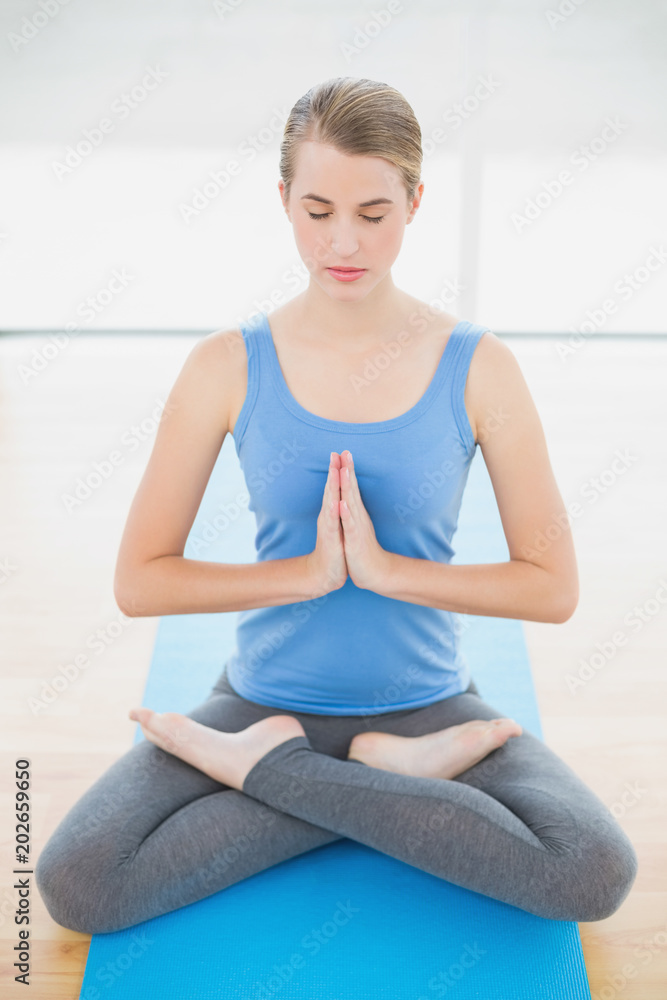 Peaceful attractive blonde relaxing in lotus position Peaceful attractive blonde relaxing in lotus position