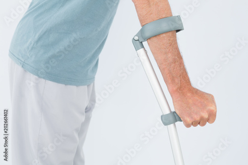 Closeup mid section of a man with crutch