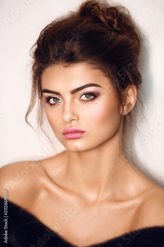 Portrait of beautiful young brunette woman with makeup