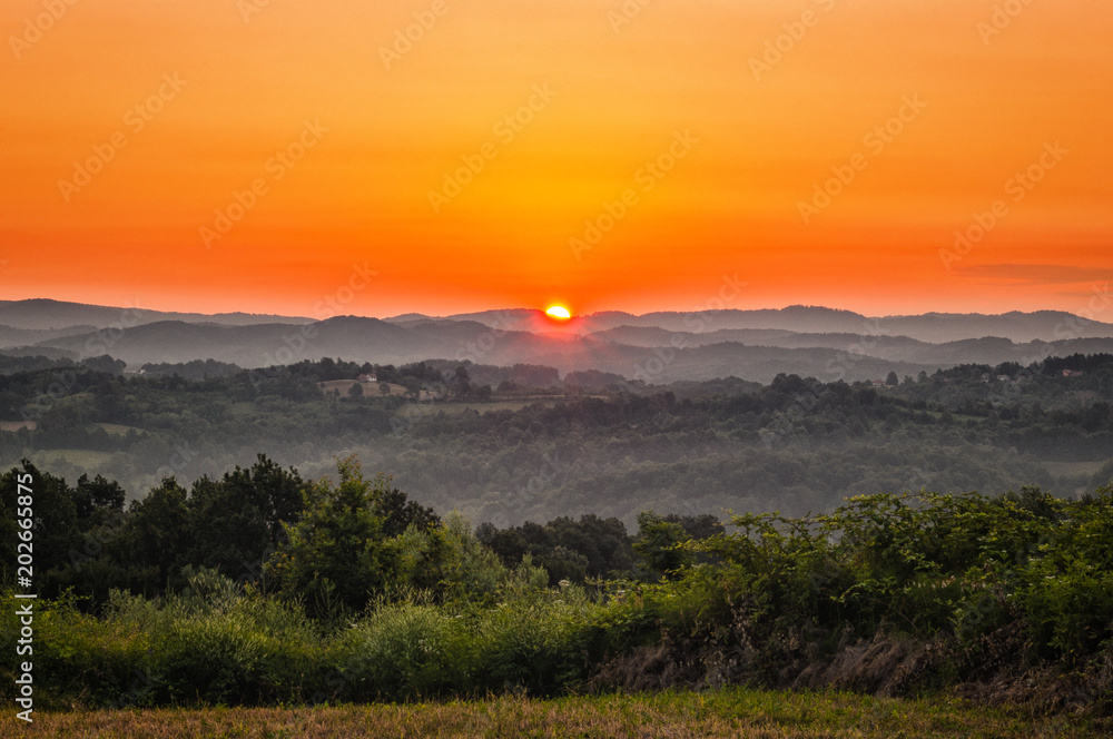 Amazing morning sunrise over the green hills
