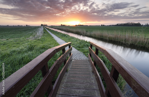 sunrise over cycling path and bridge