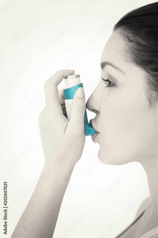 Woman using asthman inhaler against white background Woman using asthman inhaler against white background
