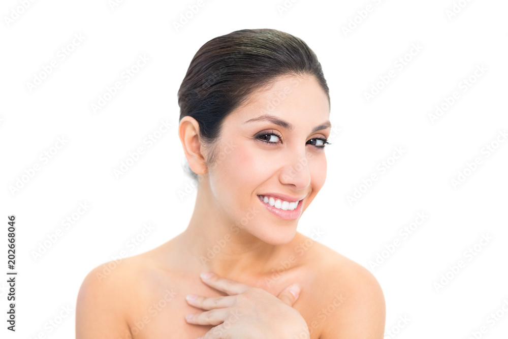 Smiling brunette looking at camera with hand on chest Smiling brunette looking at camera with hand on chest