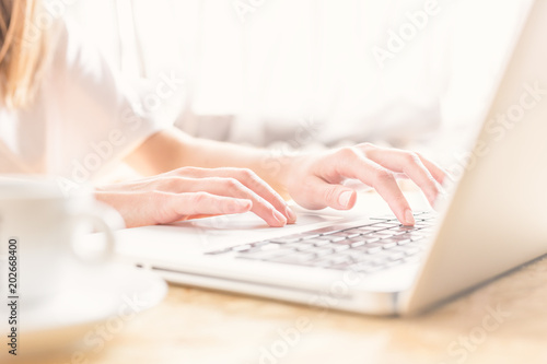Woman typing on laptop at work.