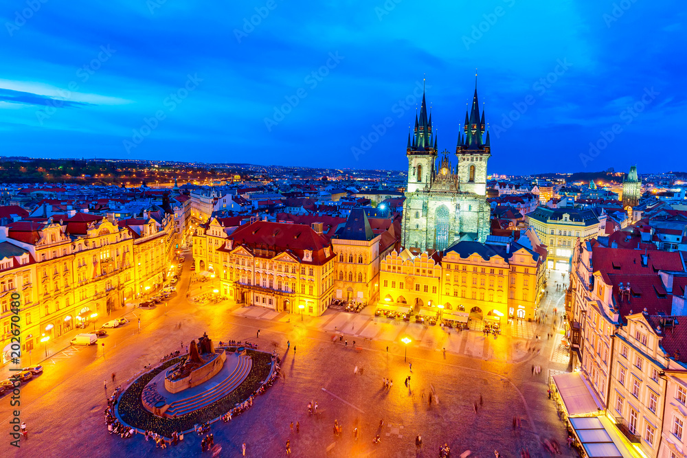 Fototapeta premium Buildings on the Old Town square Staromestska Namesti with Tyn Church in Prague during sunset, Czech Republic. World famous Prague landmarks during twilight