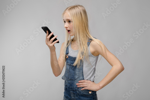 Young girl presenting telephone