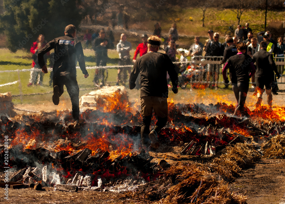 Фотография People jumping over fire