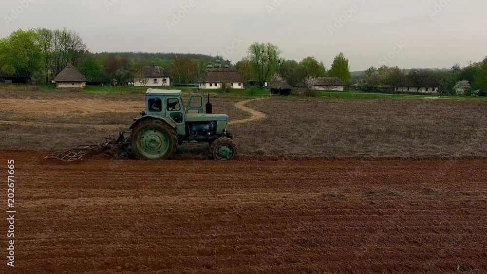 tractor on the field aerial view, 4k aerial view of tractor of Tractor plowing field, flight over field with tractor, fly over the Tractor plowing field tractor on the field aerial view, 4k aerial view of tractor of Tractor plowing field, flight over field with tractor, fly over the Tractor plowing field