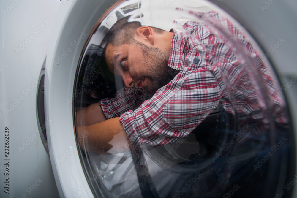 Uniformman repairing laundry machine Uniformman repairing laundry machine