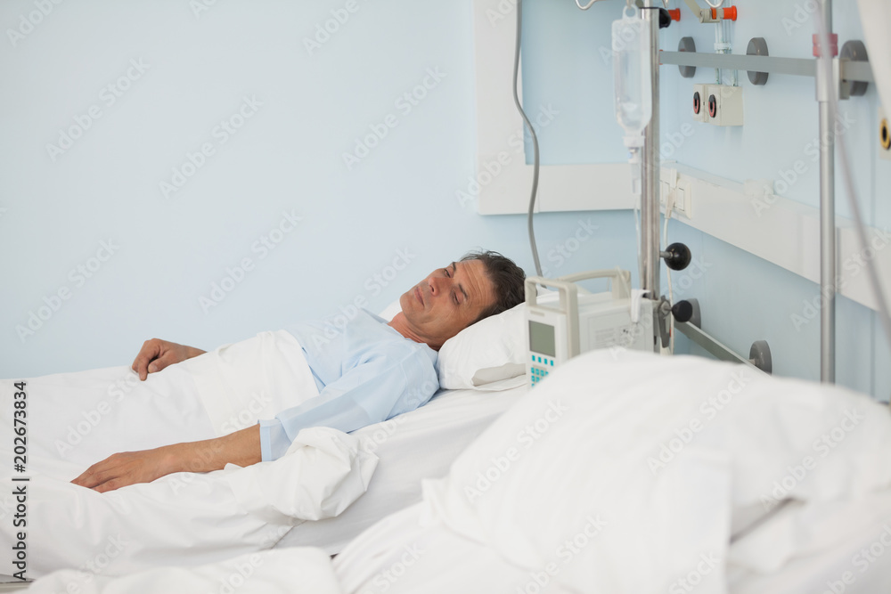 Male patient lying on a medical bed Male patient lying on a medical bed