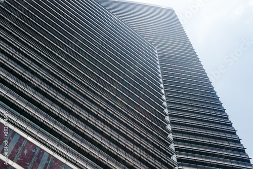 Facade of modern skyscraper in Kuala-Lumpur, perspective view.