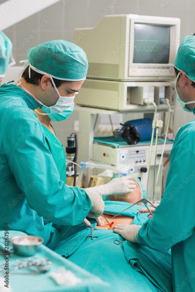 Surgeons using surgical tools Surgeons using surgical tools