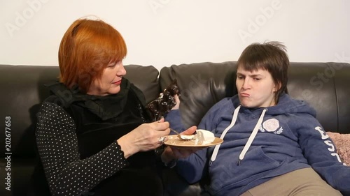 Woman feeding mentally disabled daughter 
