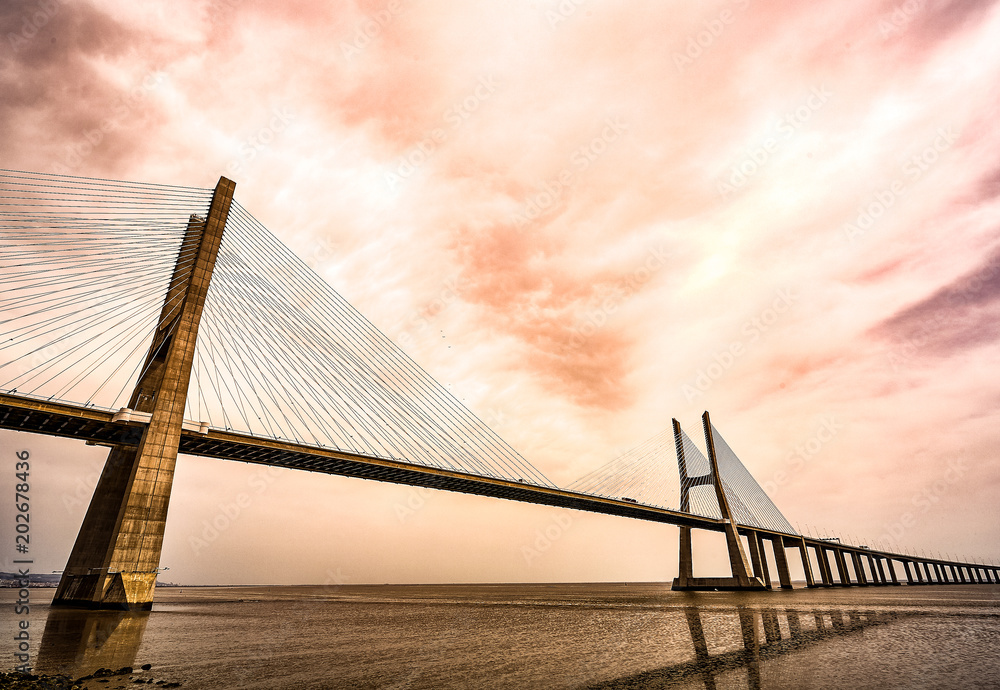 Obraz premium The Vasco da Gama Bridge in Lisbon, Portugal in a summer day. beautiful colors