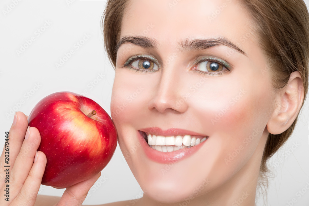 Face of a beautiful blonde woman with a red apple in her hand Face of a beautiful blonde woman with a red apple in her hand