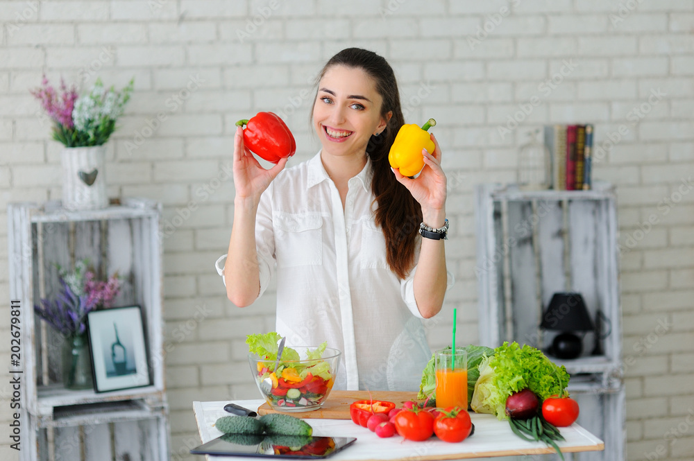 Young Woman Cooking. Healthy Food - Vegetable Salad. Diet. Healthy Lifestyle. Cooking At Home. Prepare Food Young Woman Cooking. Healthy Food - Vegetable Salad. Diet. Healthy Lifestyle. Cooking At Home. Prepare Food