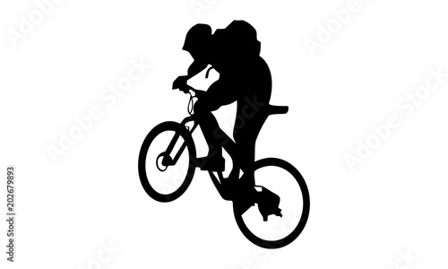 vector boy riding a mountain bike on the way uphill with a backpack © mbarep
