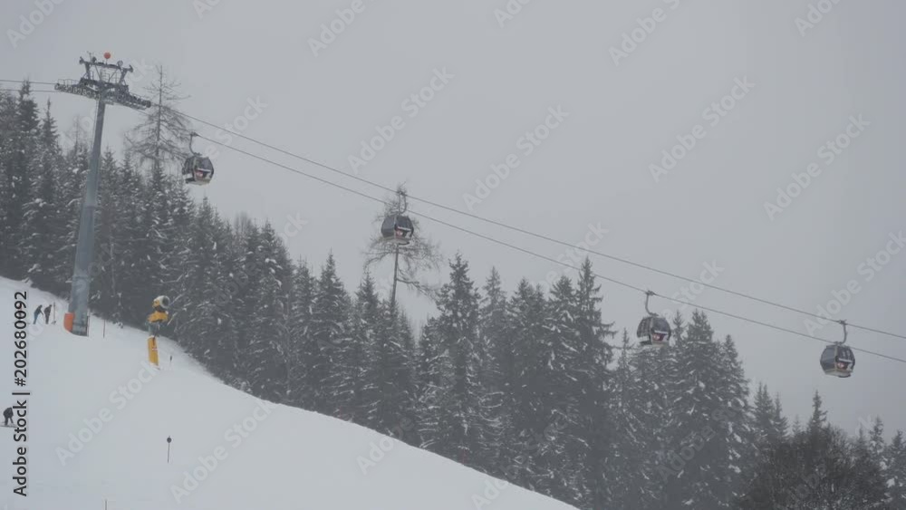 Cable car traveling over ski slope Cable car traveling over ski slope
