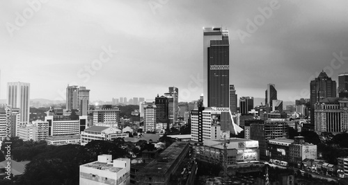 Sunset over Kuala Lumpur skyscrapers in Malaysia. Aerial view of the city. Black and white