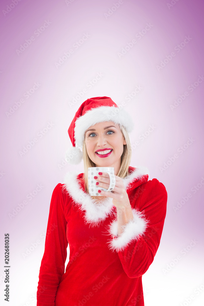 Festive blonde holding a mug on vignette background Festive blonde holding a mug on vignette background