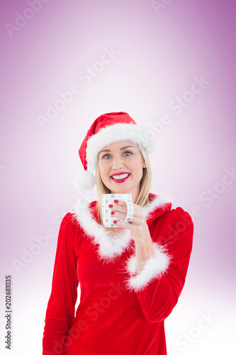 Festive blonde holding a mug on vignette background