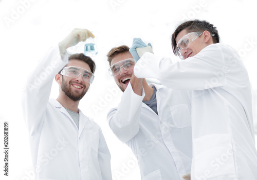 happy scientists look at the result of their work