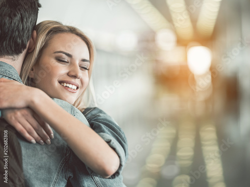 Portrait of happy woman hugging male. Copy space. Positive couple concept © Yakobchuk Olena