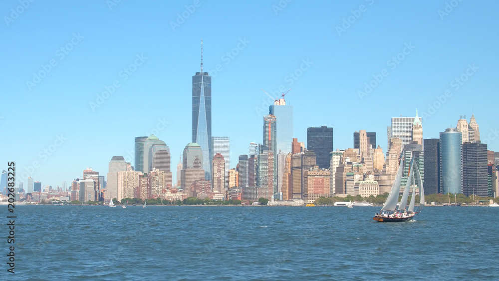 Tourists on scenic New York City sightseeing boat tour on beautiful sailboat